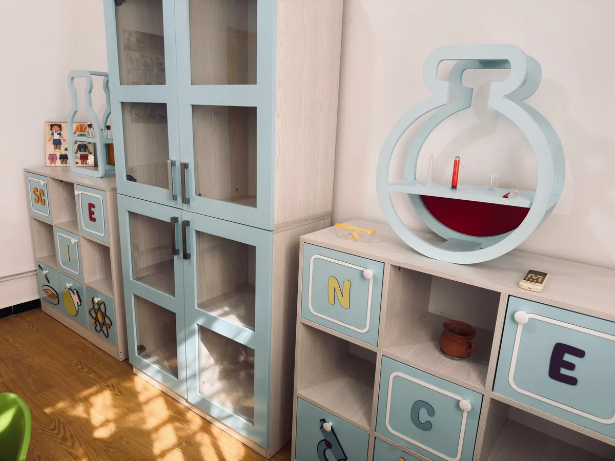 Light blue storage units spelling “SCIENCE” and a flask-shaped shelf.